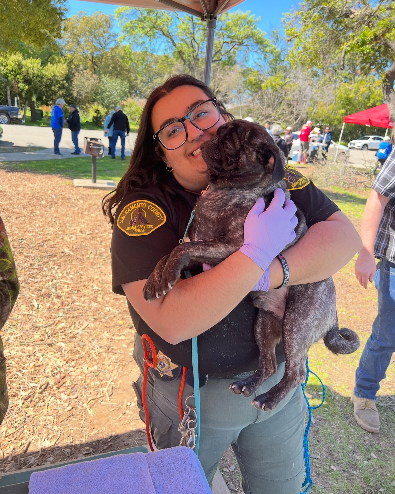 Animal Control officer holding a dog outside